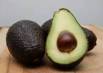 Fresh avocados, one cut open